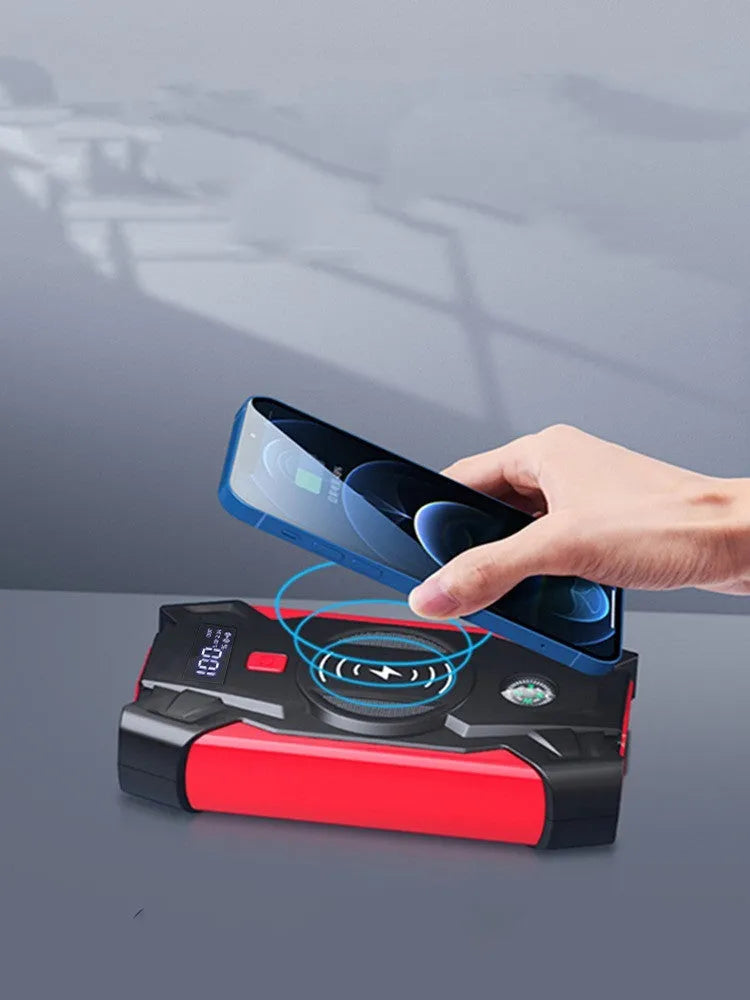 Red portable car jump starter power bank with heavy-duty jumper cables and a storage case.