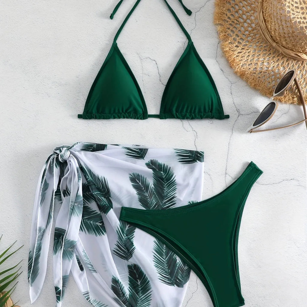 Orange three-piece swimsuit set showing bikini top, bottom, and a loose printed gauze skirt on a mannequin.