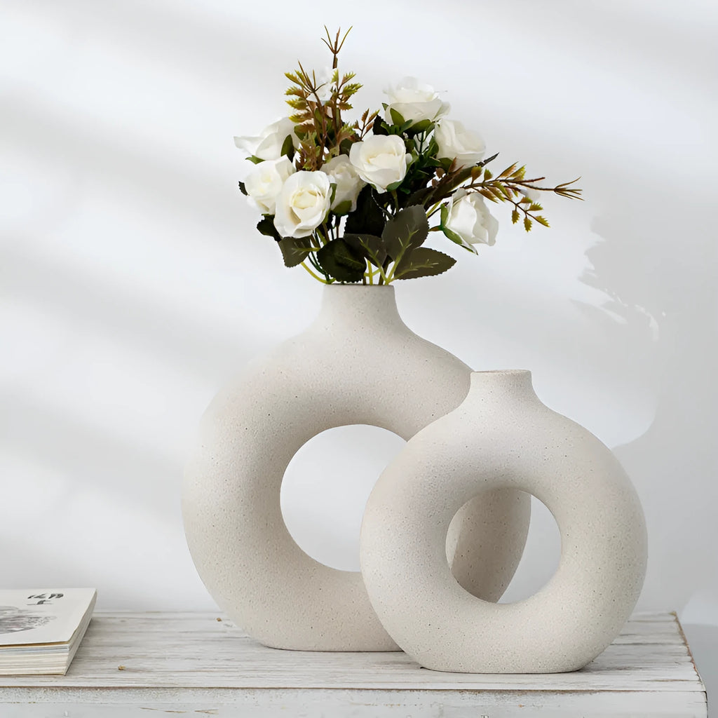 Frosted unglazed porcelain biscuit vase in a simple modern style on a table.