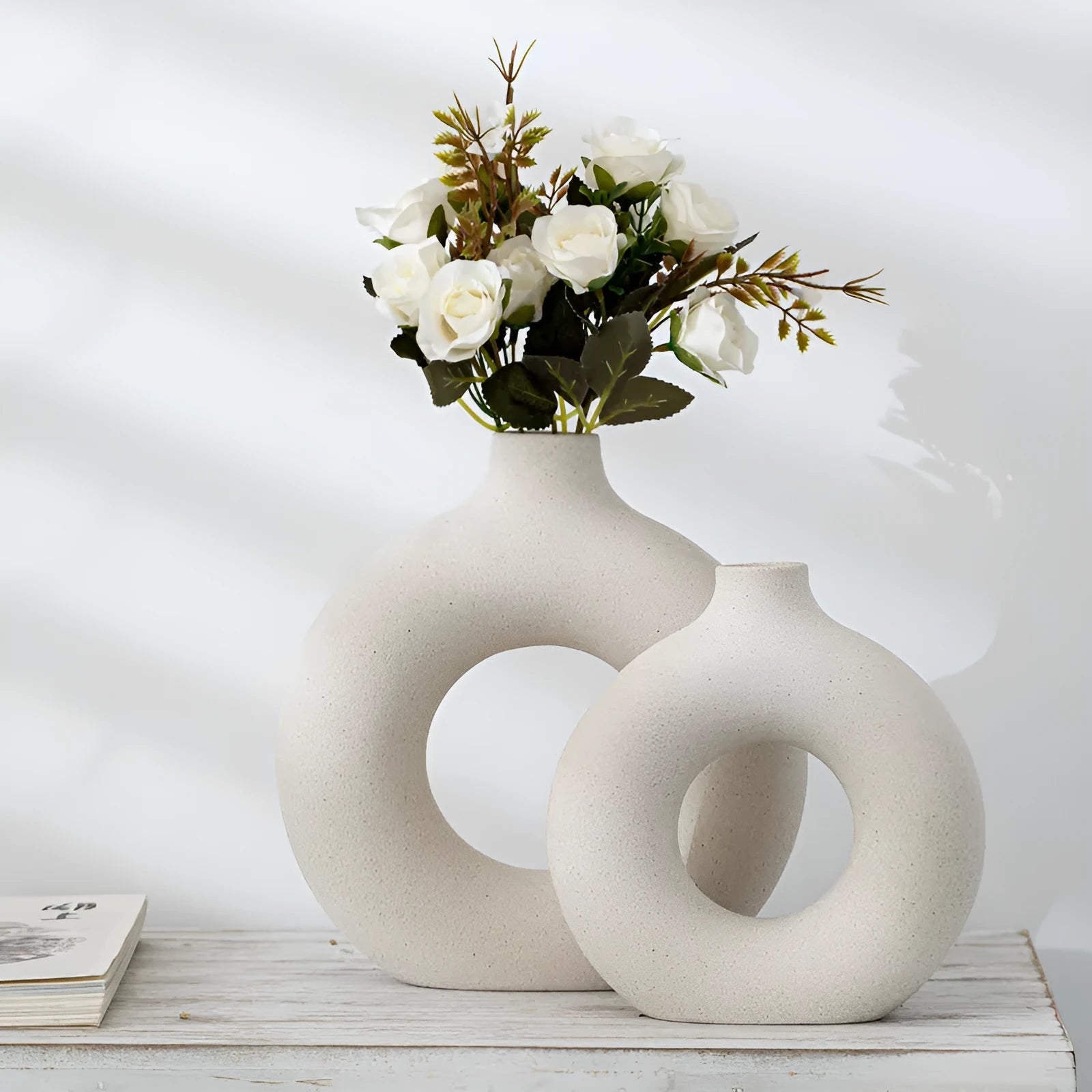 Frosted unglazed porcelain biscuit vase in a simple modern style on a table.