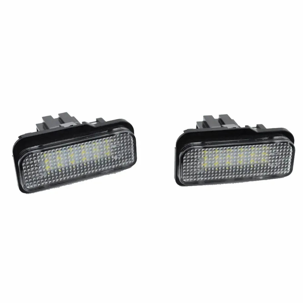Mercedes Benz LED licence plate light unit with 18 white LEDs, shown next to a ruler for scale.