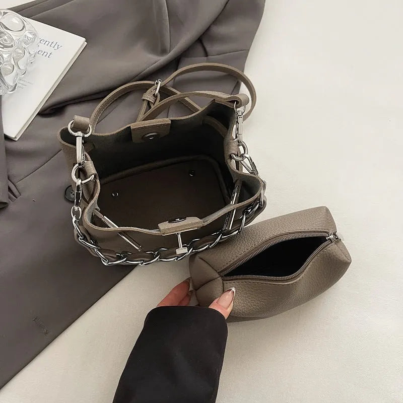 Soft PU leather retro bucket shoulder bag in black showing internal organiser pockets.