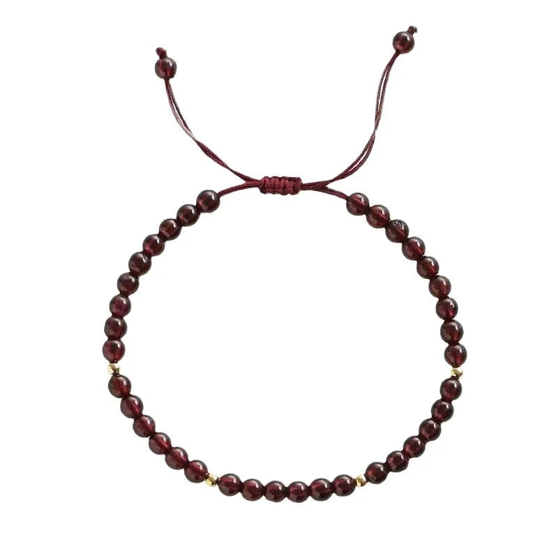 Hand-woven garnet red rope bracelet with flexible wire on a neutral background.
