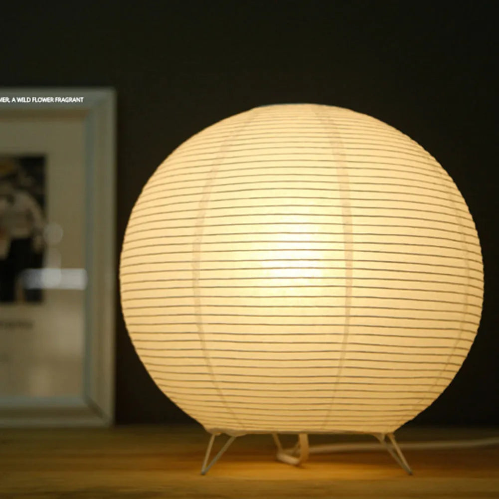White rice paper plug-in table lamp with traditional shade on wooden surface