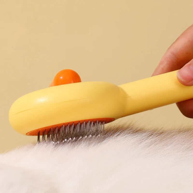 Small yellow duck-shaped pet grooming comb with open sections for cats and dogs
