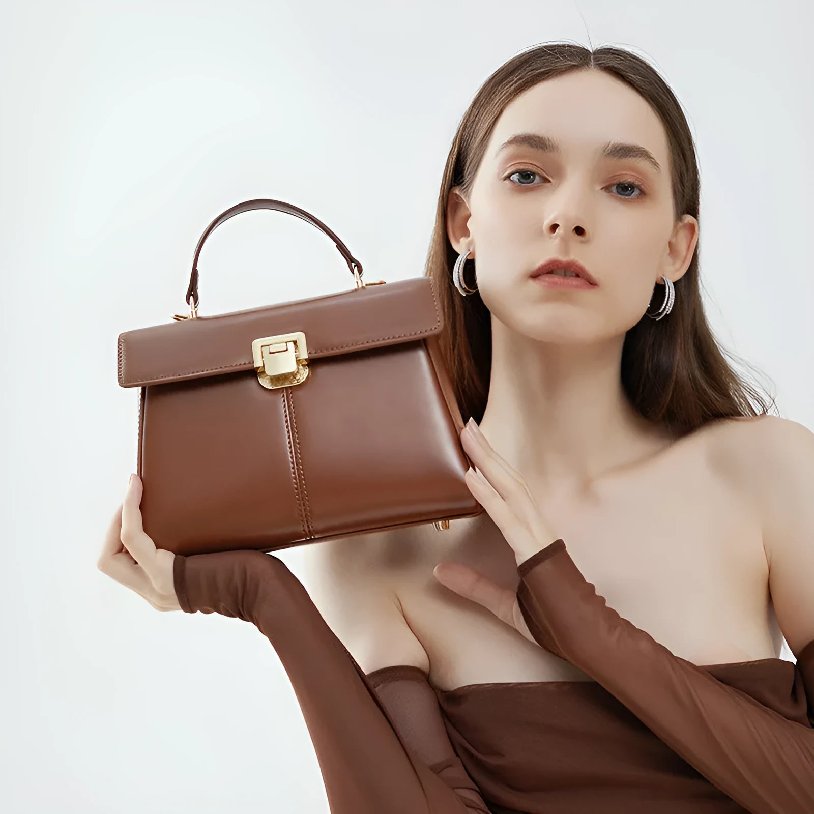 Black genuine leather women's shoulder bag with a vachette clasp, shown open to reveal a zippered hidden pocket.