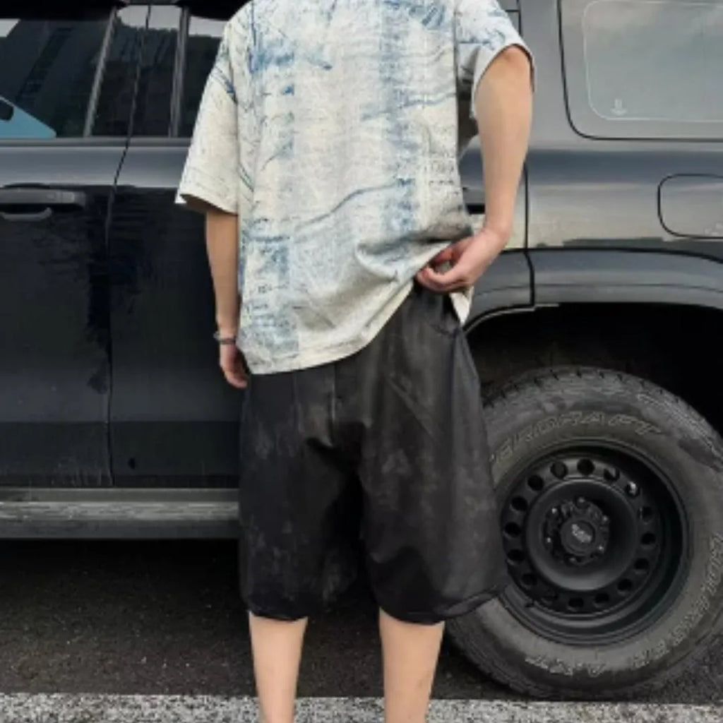 Man wearing a loose-fit Korean-style T-shirt with a dirty print effect and round neck.