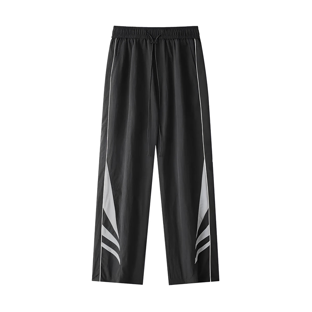 Men's loose fit straight-leg trousers in black, featuring an elasticated waist and button fly.