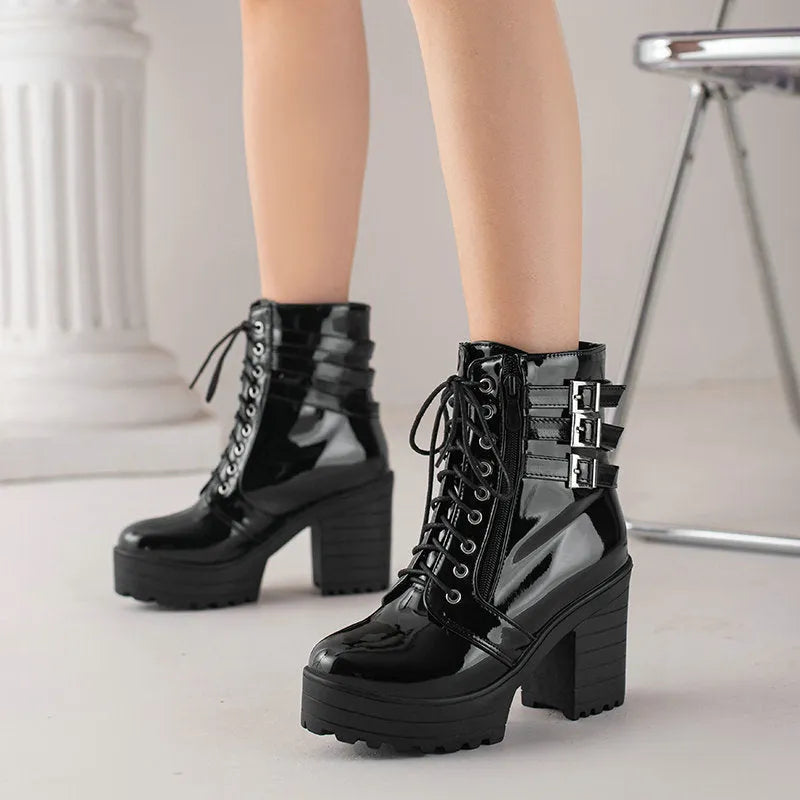 Women's black thick-heeled ankle boots with lace-up front and round toe on a waterproof platform