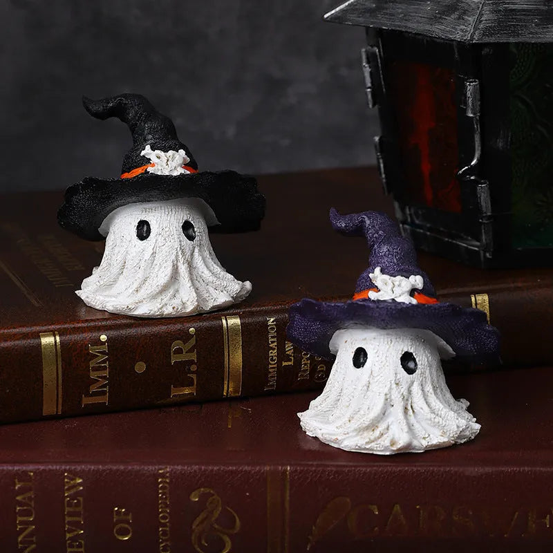 Close-up of a detailed black and a purple resin wizard hat ornament for holiday decoration.