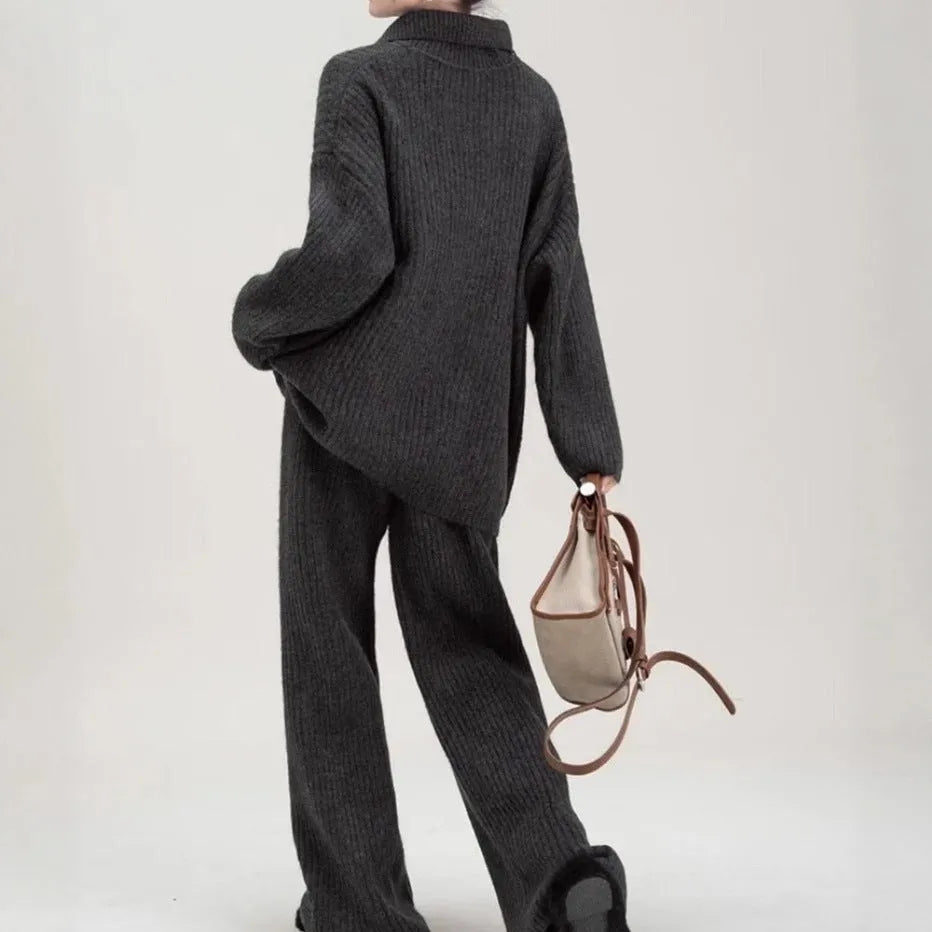 A dark grey sweater suit two-piece set featuring a long-sleeved knit top and matching casual trousers.