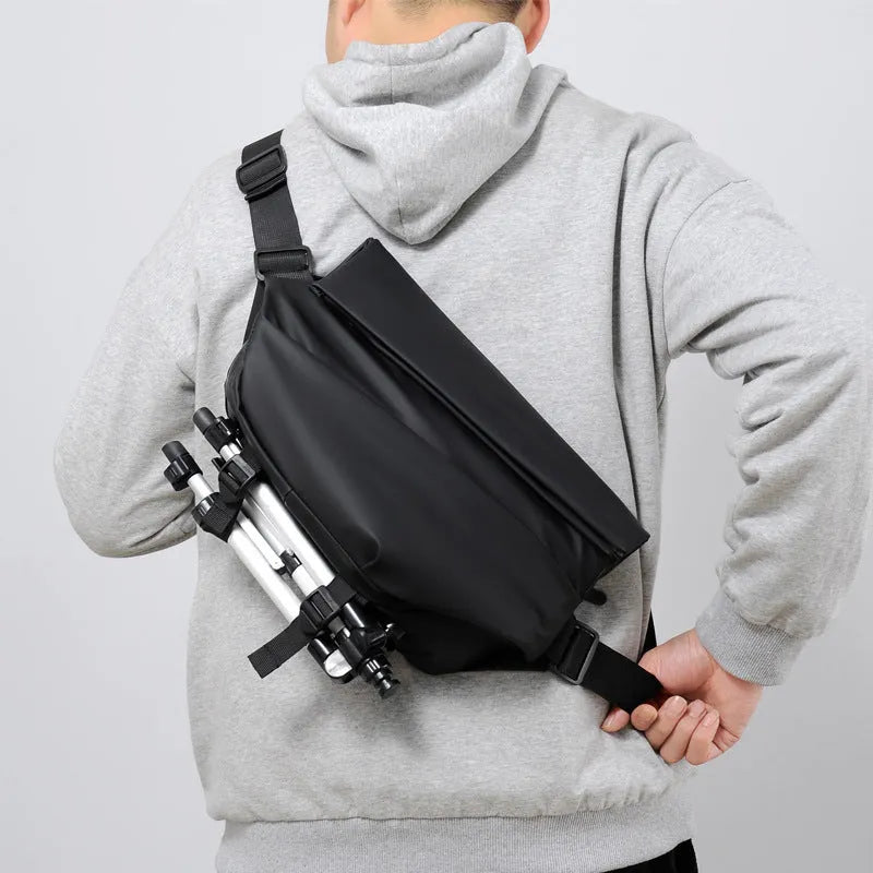 Grey horizontal square men's crossbody bag made of PU leather with a zipper and shoulder strap.
