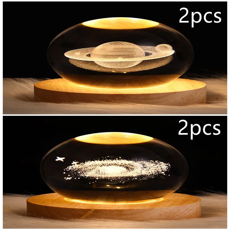 LED galaxy crystal ball night light with 3D planet designs on a table
