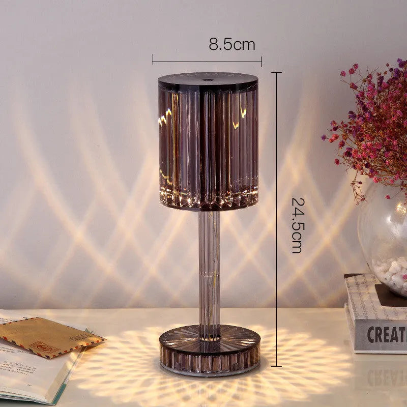 Modern crystal table lamp with a diamond-faceted shade on a metal stand, showing amber colour option.