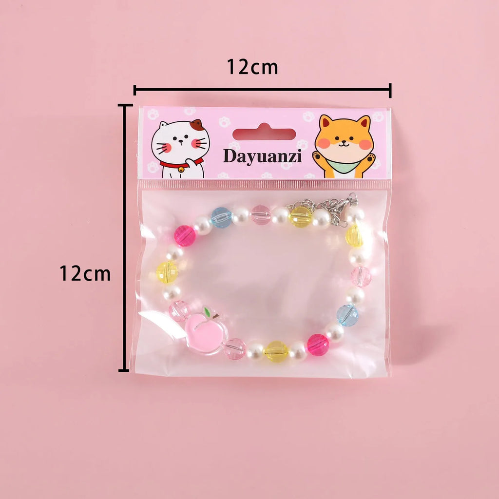 Colourful pearl bead pet necklace in small flower, rainbow, or peach designs with adjustable sizing for cats and small dogs.