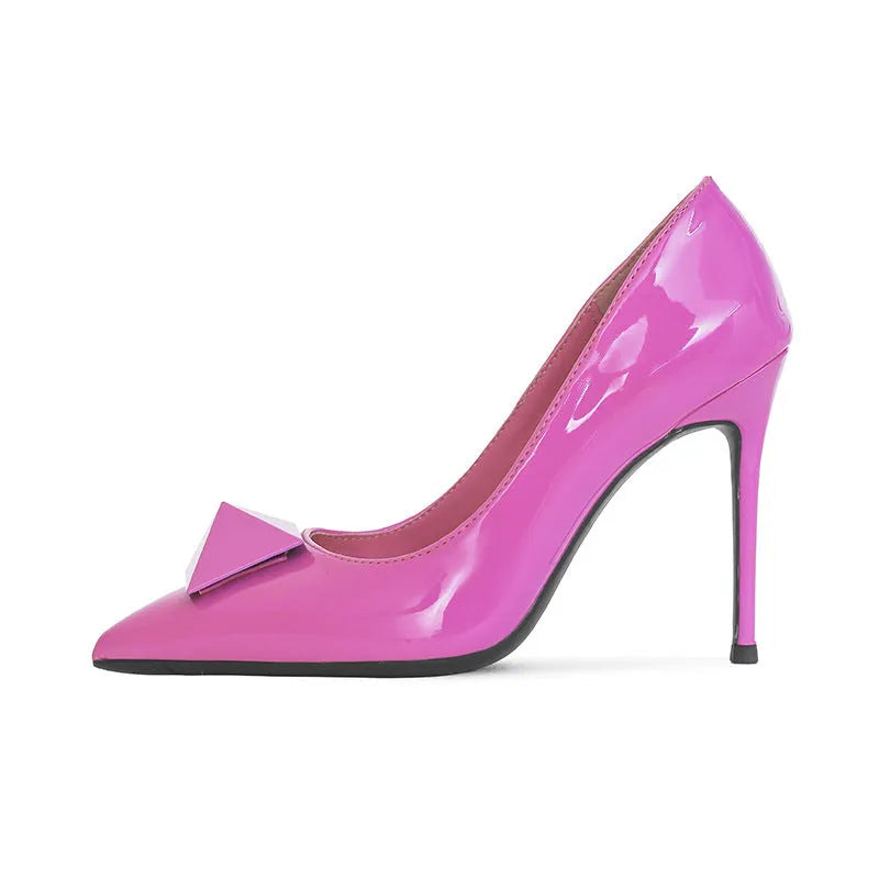 Pink women's pointed toe stiletto high heels with buckle detail on patent leather upper.