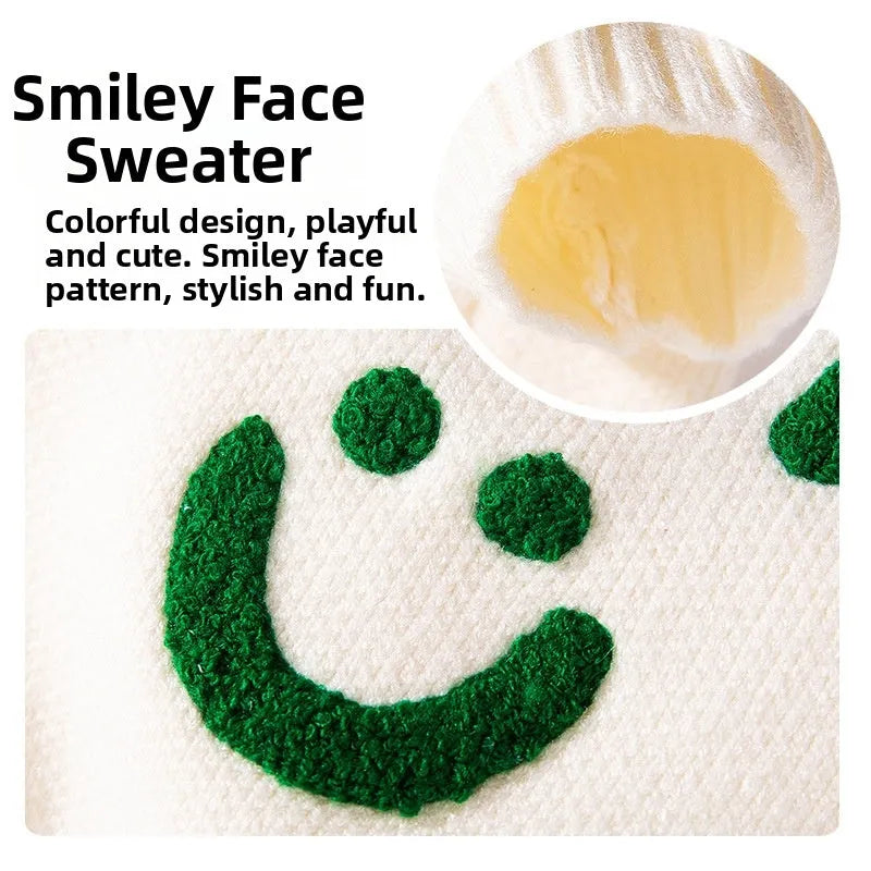 White knitted small dog sweater with rainbow Apple embroidery and green smiley face on a pet