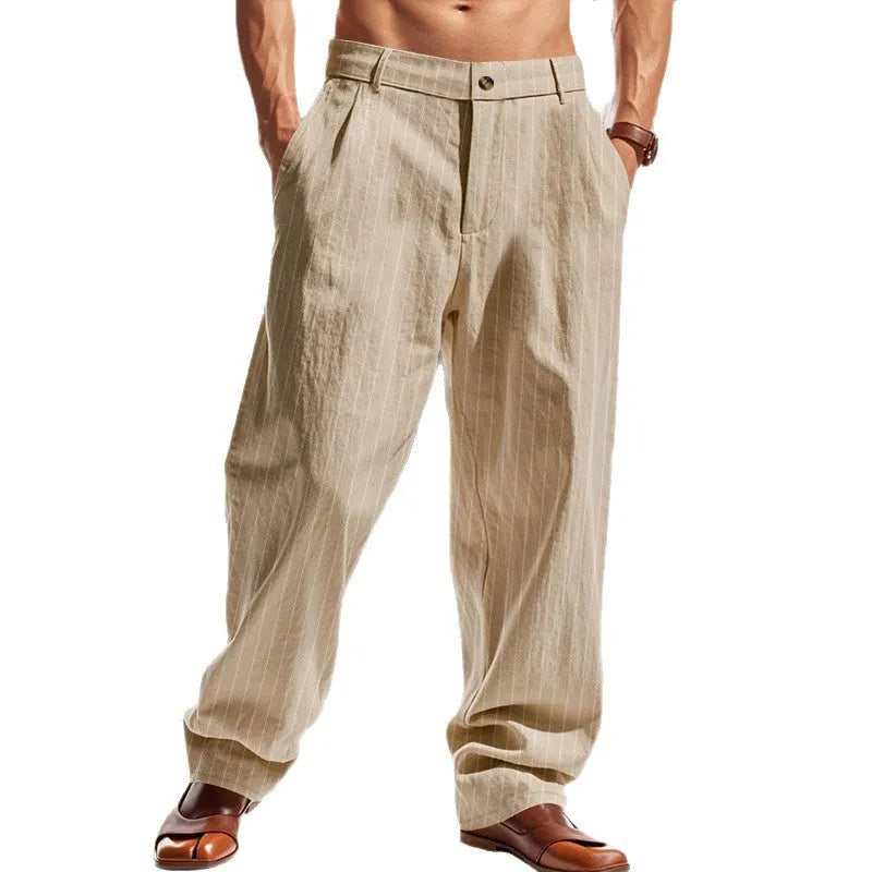 Man wearing loose-fit high-waist striped linen trousers in a light blue colour.
