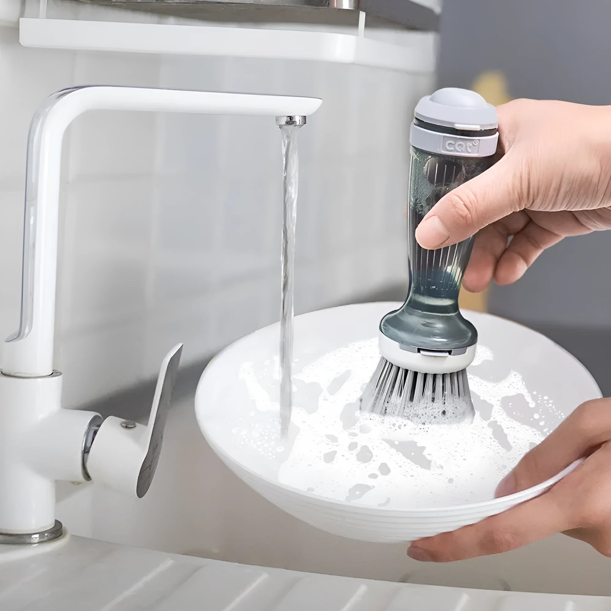 Milk white pot brush with soap dispenser in handle and non-scratch bristles for kitchen sink use.