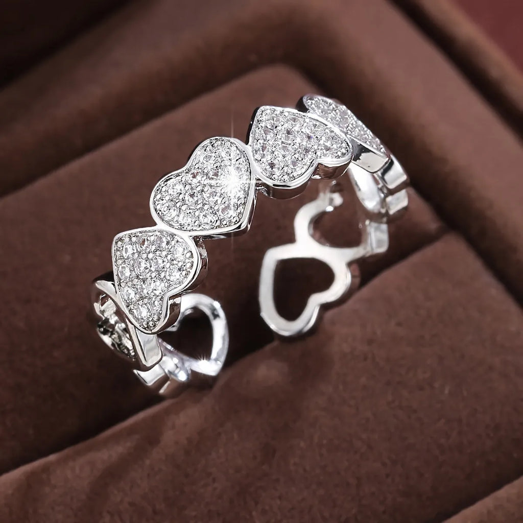 Adjustable gold and silver couples ring with love heart design on a geometry band.