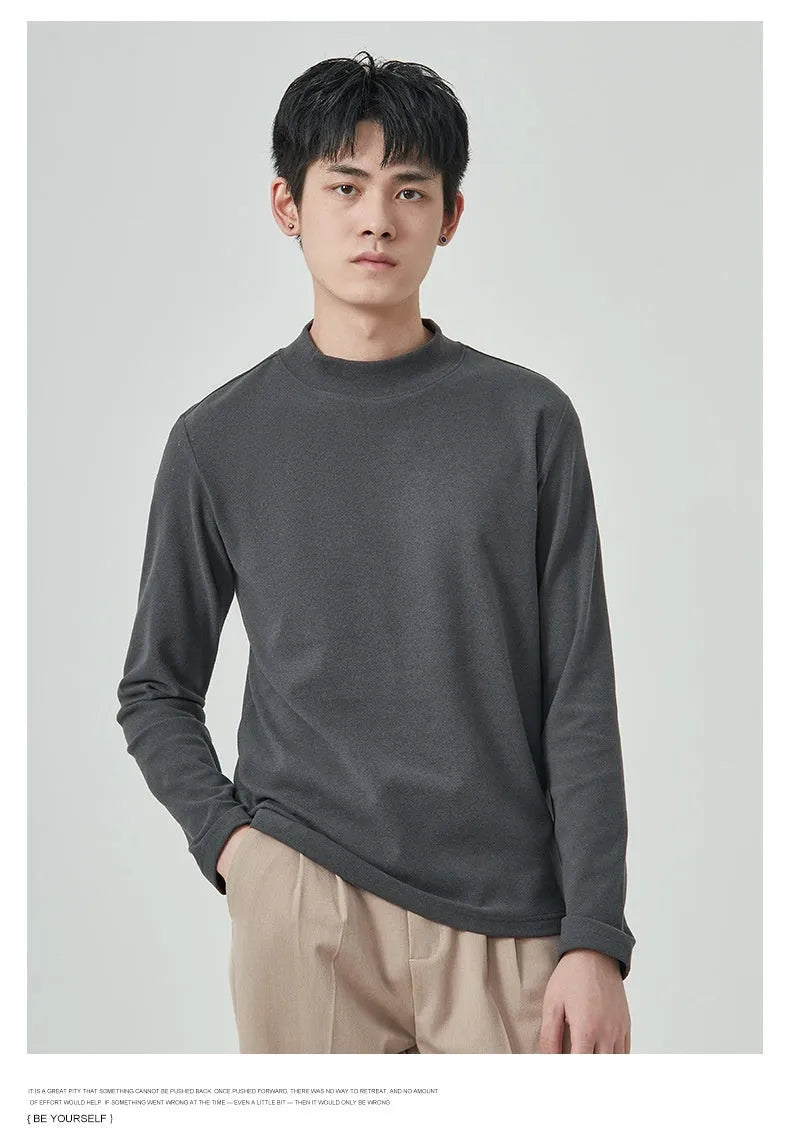 Man wearing a beige Dralon long sleeve T-shirt with a half-high collar, casual autumn outfit.