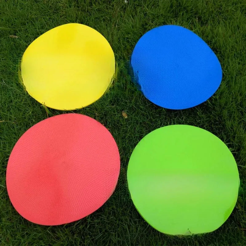 Yellow TPE football training landmark pad, 23cm diameter flat disc on grass.