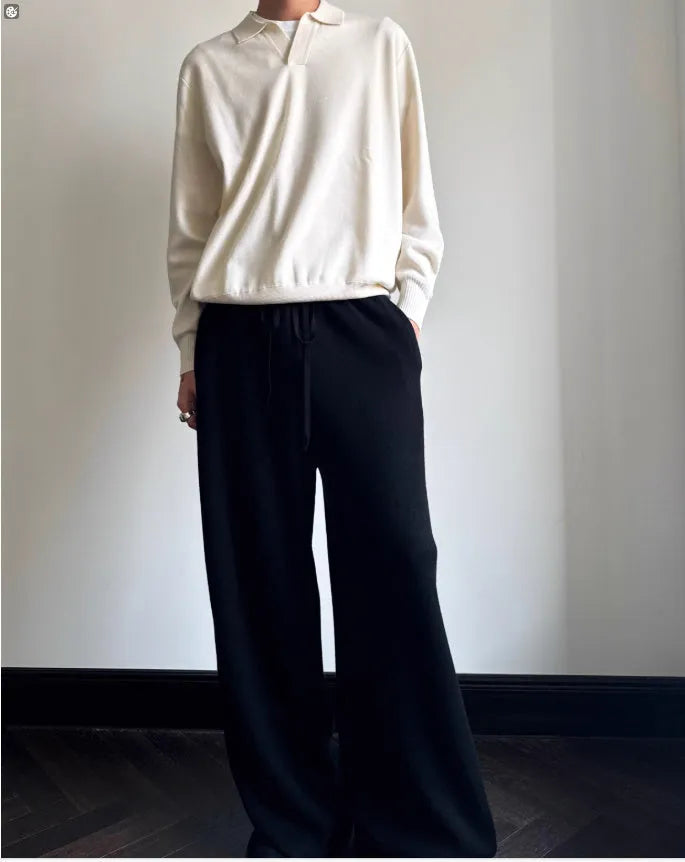 Man wearing a milky white pure wool polo sweater with a lapel collar, showcasing its loose fit.