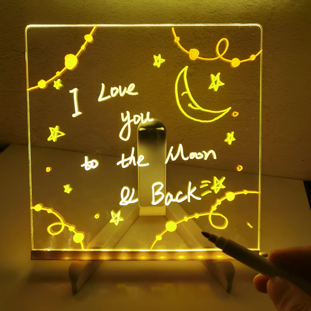Acrylic LED message board night light on a desk with colourful handwritten notes glowing softly.