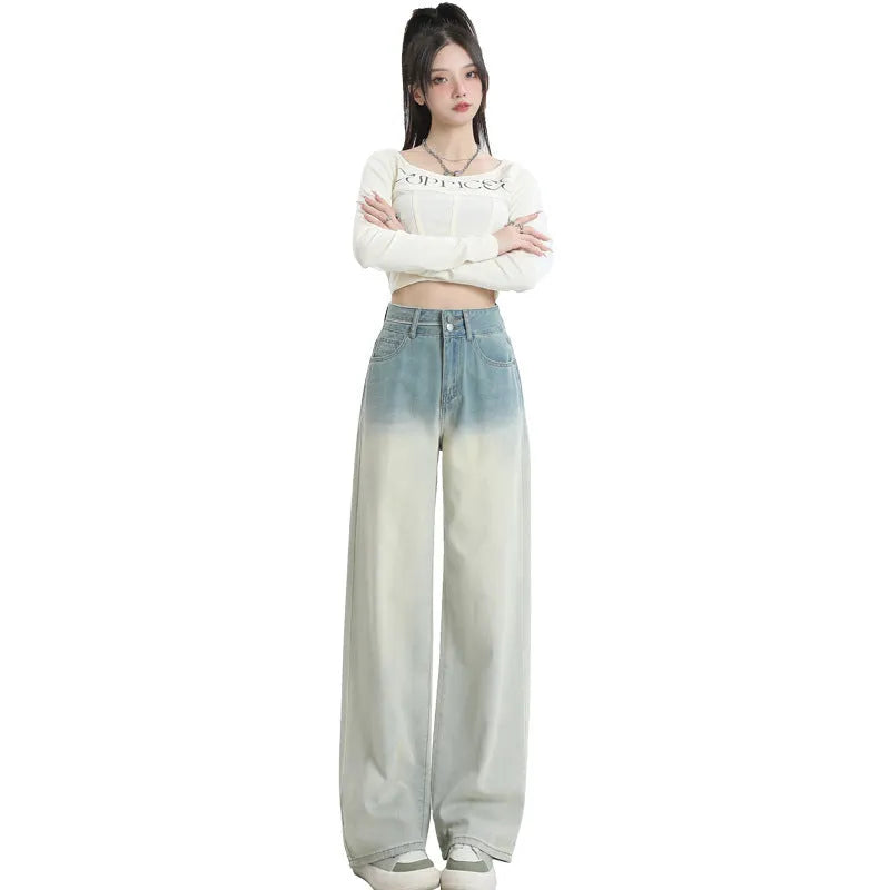 Gradient blue women's straight-leg denim trousers on a hanger, showing colour transition.