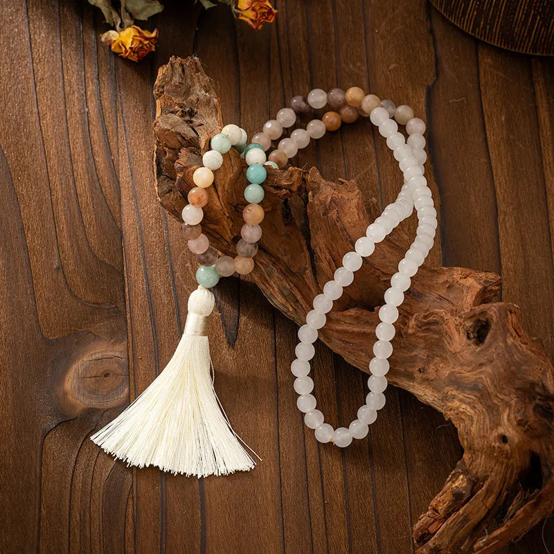 Vintage bohemian long necklace with tassel and stone beading alongside matching bracelet in geometric ball bead design