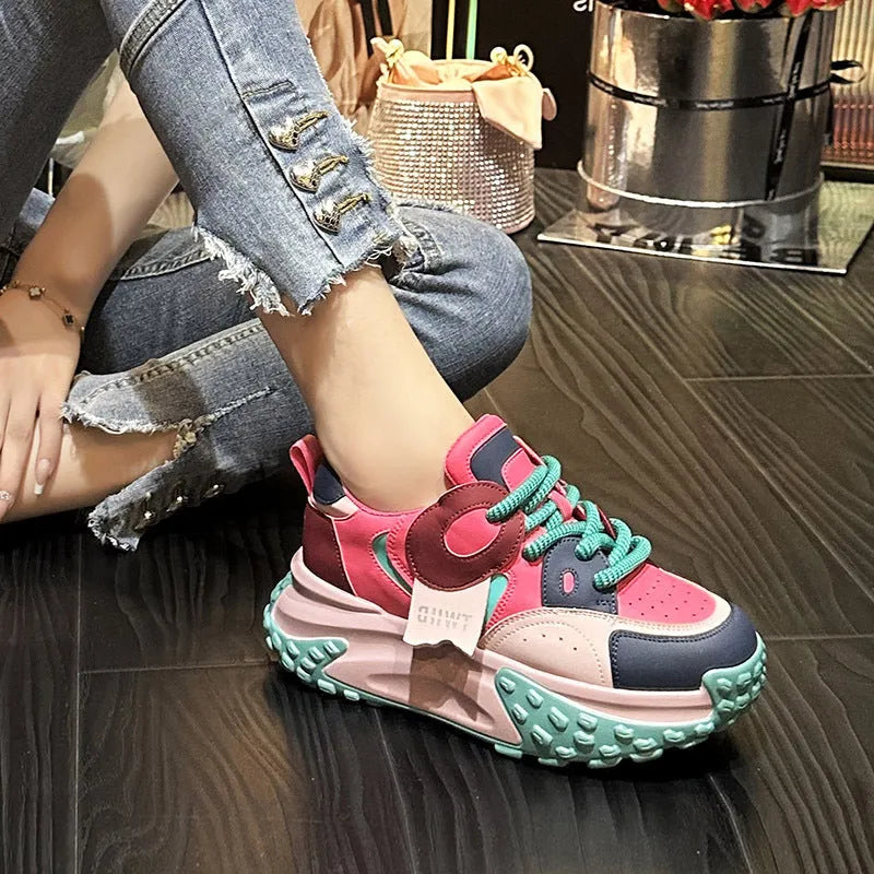 A pair of thick-soled leather sports casual shoes with a wedge heel and round toe in a lace-up design.