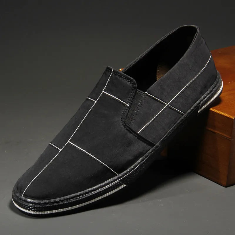 Men's low-top slip-on canvas shoes in various colours showing round toe and vulcanised rubber sole.