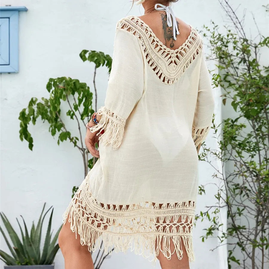 Apricot women's crocheted patchwork beach dress with half sleeves on a hanger.