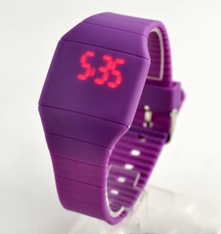 Square electronic touch screen watch showing numeric display on a coloured PU strap.
