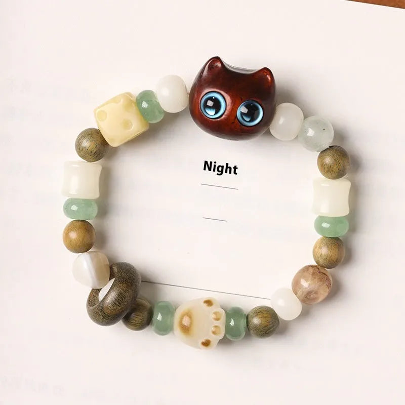 Hand-woven beaded bracelet with a cat's paw charm, jade, and wood beads in a cartoon style.