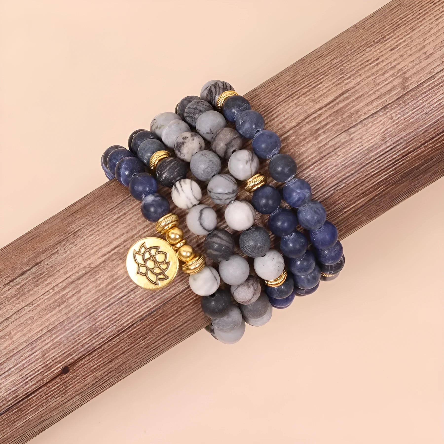 Close-up of a blue patterned network stone bead multi-layer alloy bracelet on a wrist.