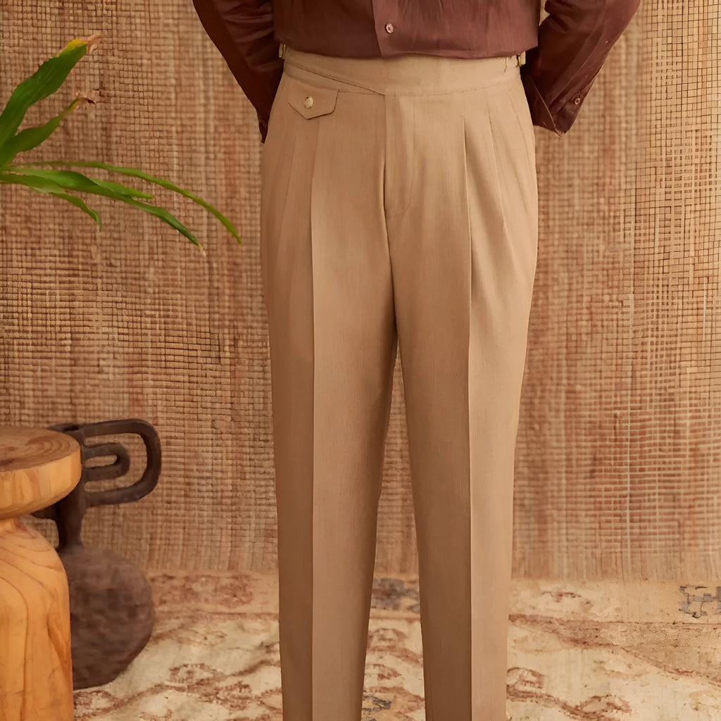 Men's slim fit straight leg trousers in dark grey, light brown, and light apricot colours on a hanger.
