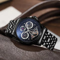 Men's automatic watch with luminous hands on a black dial, fitted on a stainless steel bracelet.