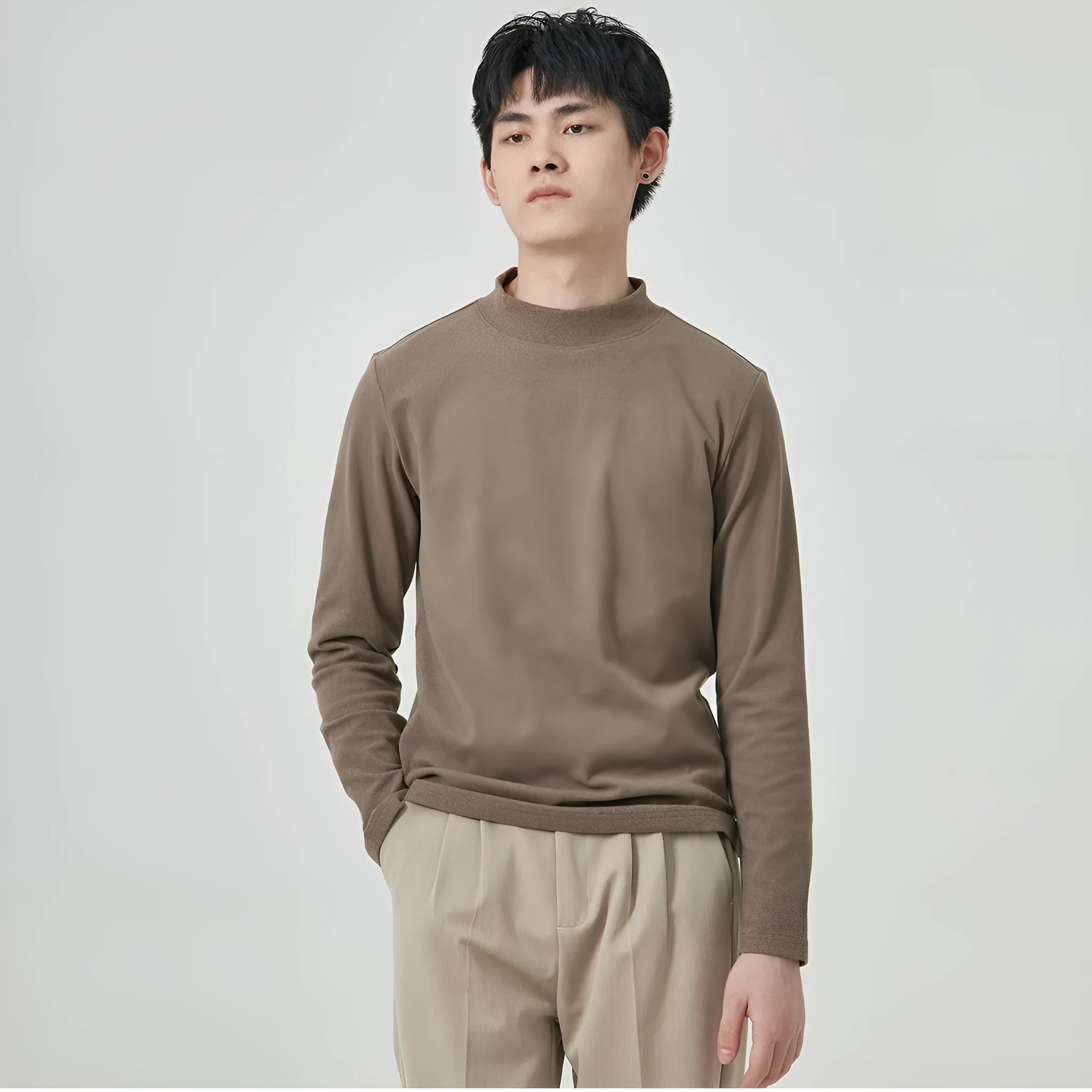 Man wearing a beige Dralon long sleeve T-shirt with a half-high collar, casual autumn outfit.