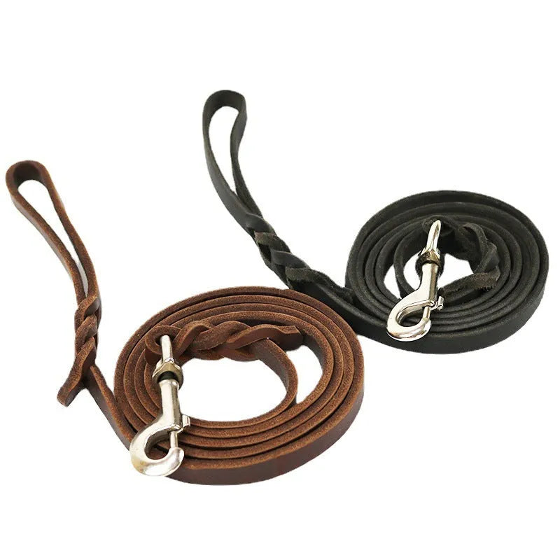 Thickened brown cowhide dog walking rope held in a hand, showing its length and simple strip design.