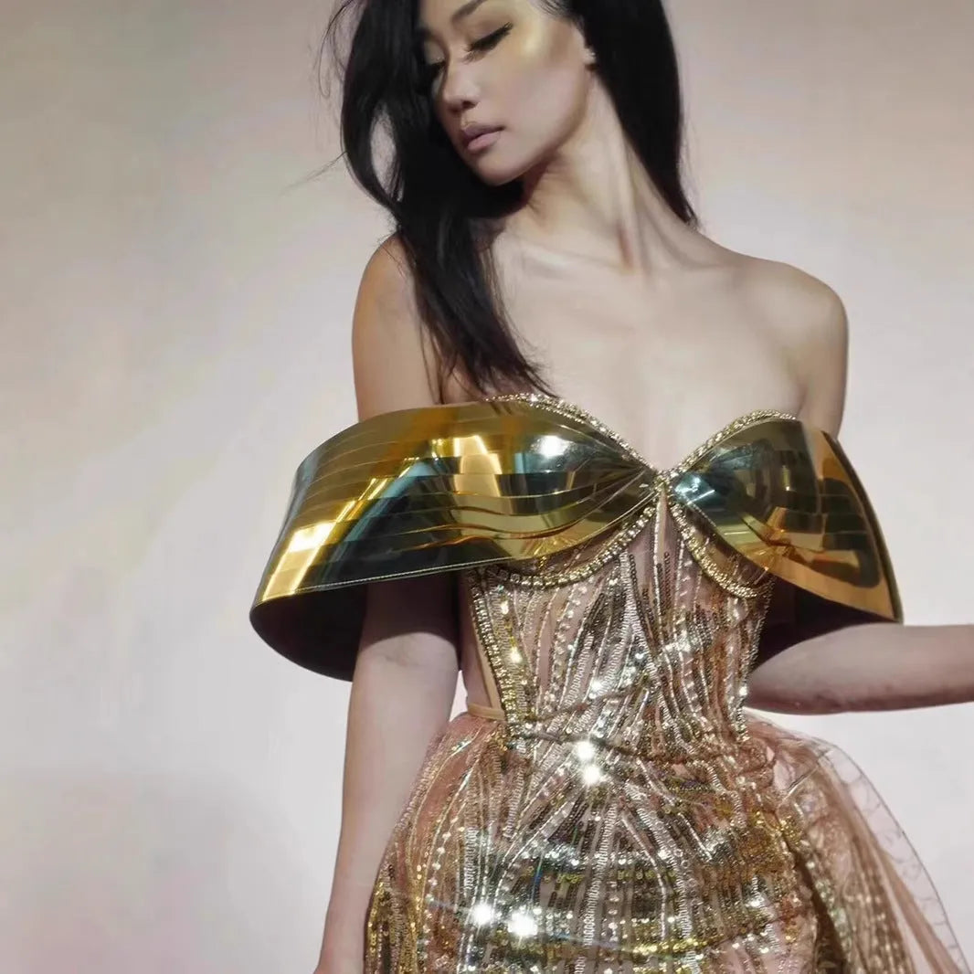 Gold strapless sequined formal dress with a side split on a long tulle skirt.