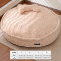 Round nest-style pet bed with a removable washable cover in a milk tea colour.