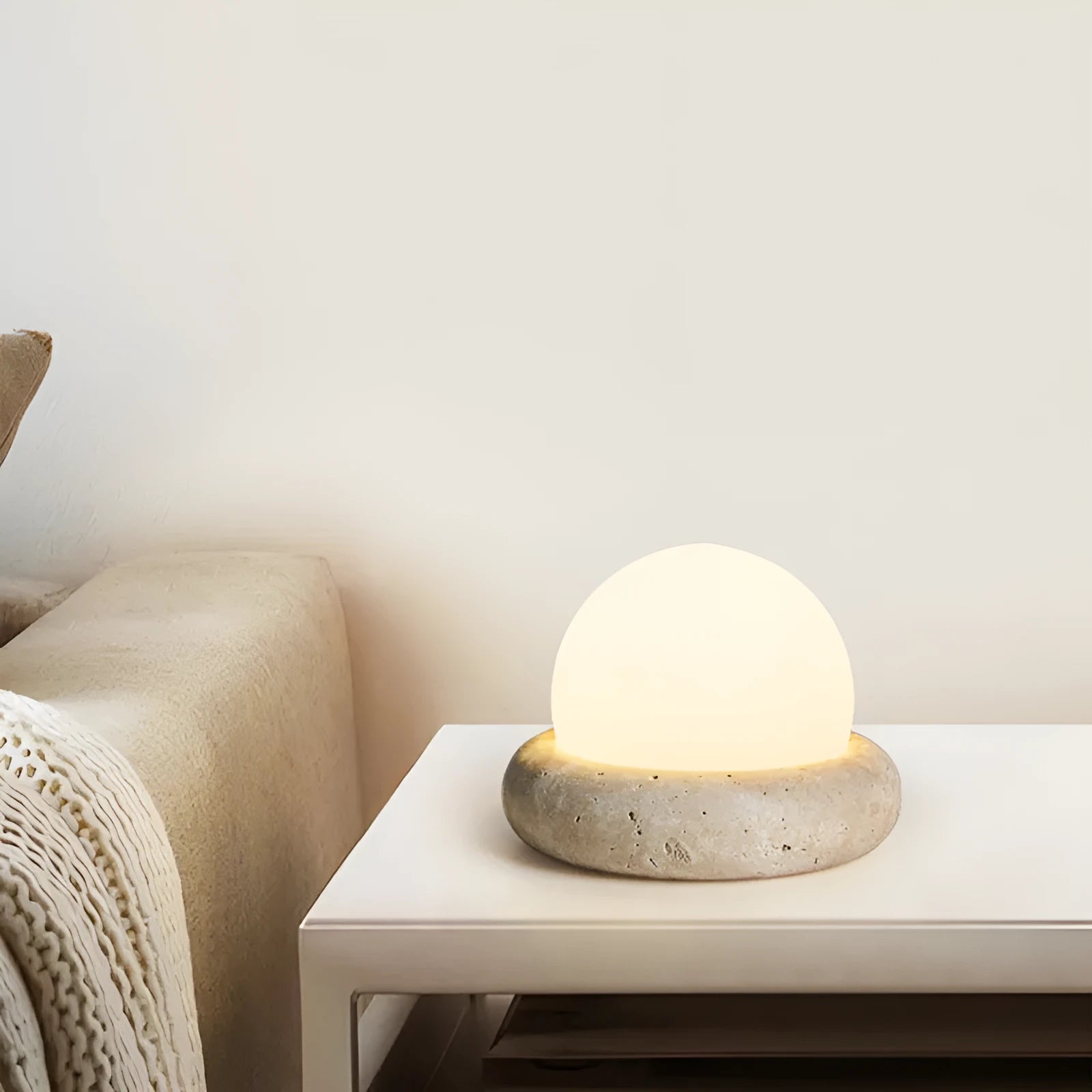 Cream coloured remote control bedside night light with circular 15.5cm diameter design