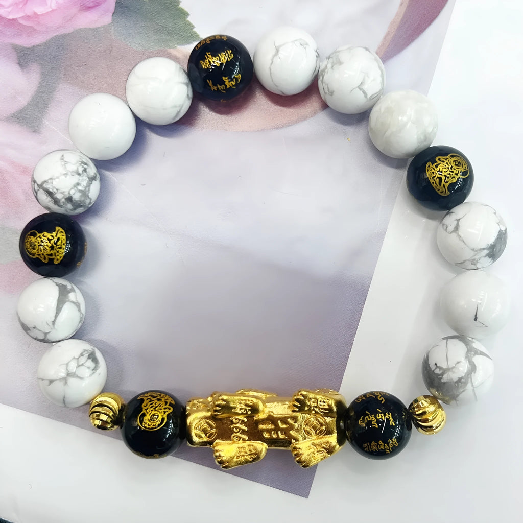 Vintage couple bracelet with white turquoise and black agate stones on a wrist.