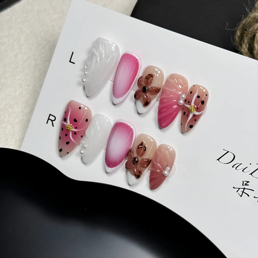Set of hand-painted 3D carved nail beauty patches in embossed and candy patterns on a plastic sheet.