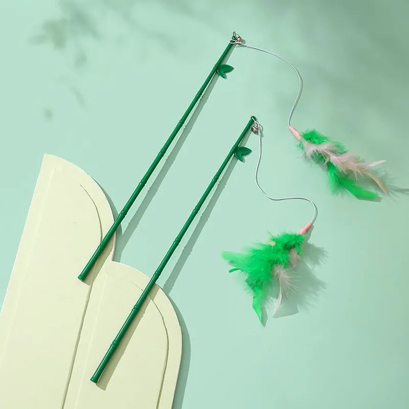 Green interactive cat feather wand toy with bells and a comfortable grip handle