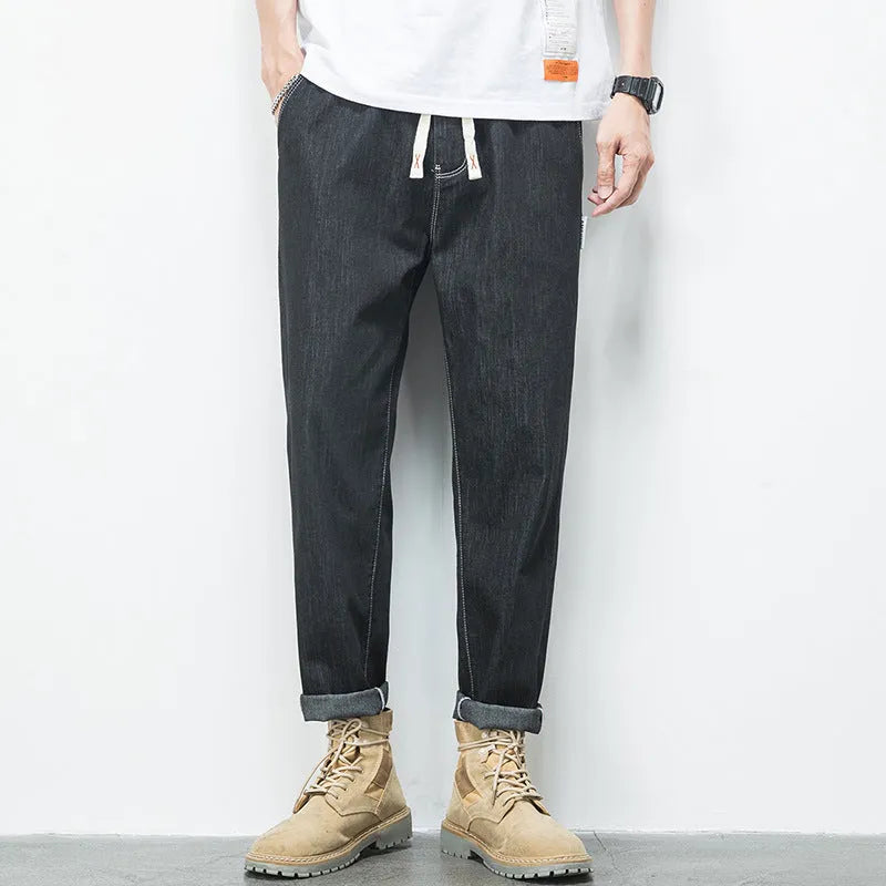 Men's loose plus size elastic waist jeans in blue cotton denim with mid waist straight leg fit