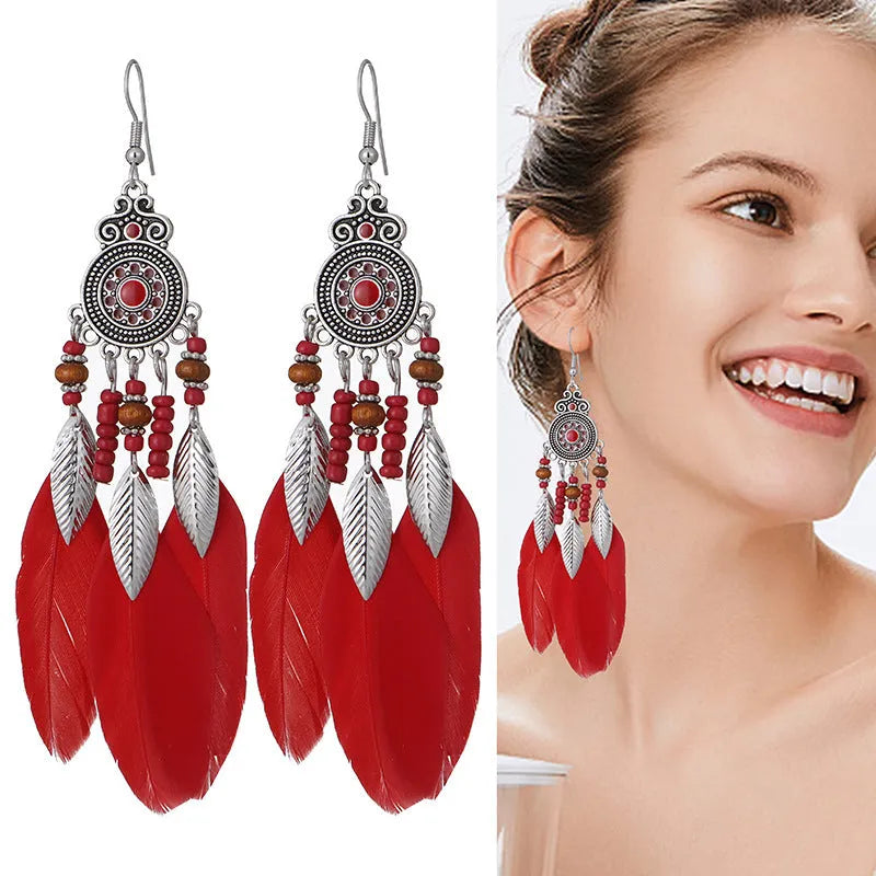 Round drop feather earrings in alloy with electroplated finish showing leaf shape and pattern details