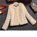 Women's short white faux fur top with regular sleeves on a hanger.