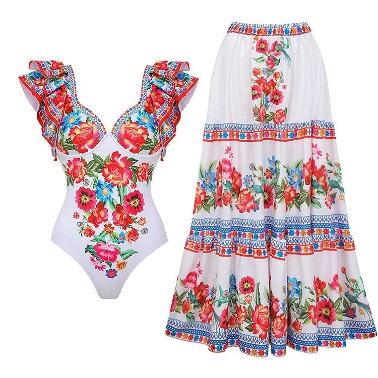 Women's printed one-piece swimsuit set with a matching cover-up skirt on a blue background.